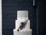 a grey and white wedding cake with textural tiers, navy sugar flowers looks unusual