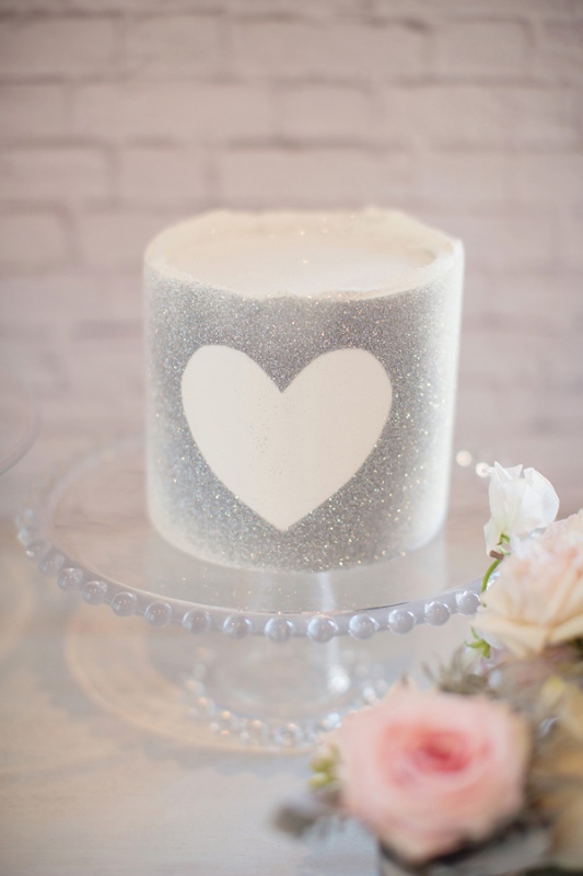 A silver grey wedding cake with a heart is a cool glam dessert for your wedding