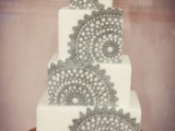 a white square wedding cake decorated with grey lace is a chic and bold dessert to try