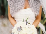a grey faux fur coverup and grey succulents and foliage to accent a neutral bridal look