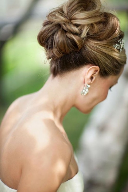 a chic twisted wedding updo with twists even on top and a shiny embellished hairpiece for a vintage or just formal bridal look