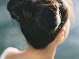 a unique and quirky wedding updo – a large bow with some volume on top and a fringe is a fun and cool idea
