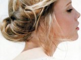 a twisted low updo with some volume on top, some hair down is a relaxed and informal idea for a bride
