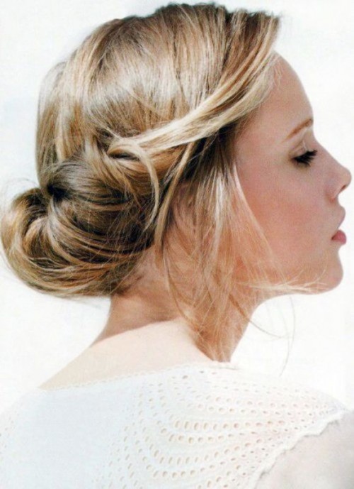 a twisted low updo with some volume on top, some hair down is a relaxed and informal idea for a bride