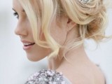 a messy and wavy updo with some volume on top, some locks down and an embellished hairpiece is a gorgeous idea to try