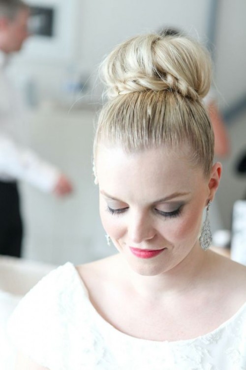 a top knot with a braided element and a sleek top is a lovely and chic idea for a modern and refined bride