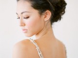 a messy wavy chignon with much volume on top is a creative and stylish idea for many bridal looks