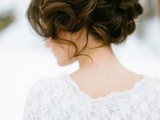 a wavy updo with some curls down and a messy voluminous top is a lovely solution for a romantic bride