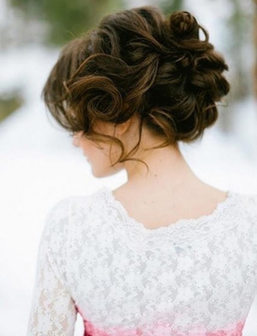 a wavy updo with some curls down and a messy voluminous top is a lovely solution for a romantic bride