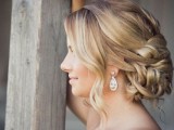 a wavy twisted low chignon with some locks down is a beautiful solution that matches many looks