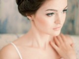 a braided  side updo with a voluminous top is a chic and cool idea for a modern bride who loves unique looks