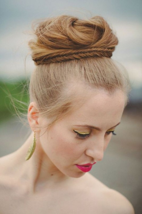 a top twisted knot with a braid around it and with a sleek top is a cool and catchy take on a traditional knot