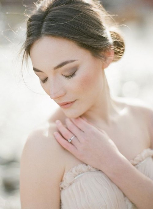 a low bun with a voluminous top is a chic and beautiful idea for a modern bride