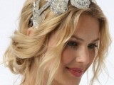 a messy and wavy low updo with some locks down and with an embellished headpiece is a gorgeous option for a bride who loves effortless chic