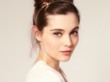 a creative-looking top knot with some volume on top and a headpiece with a bird is a stylish and bold option to rock