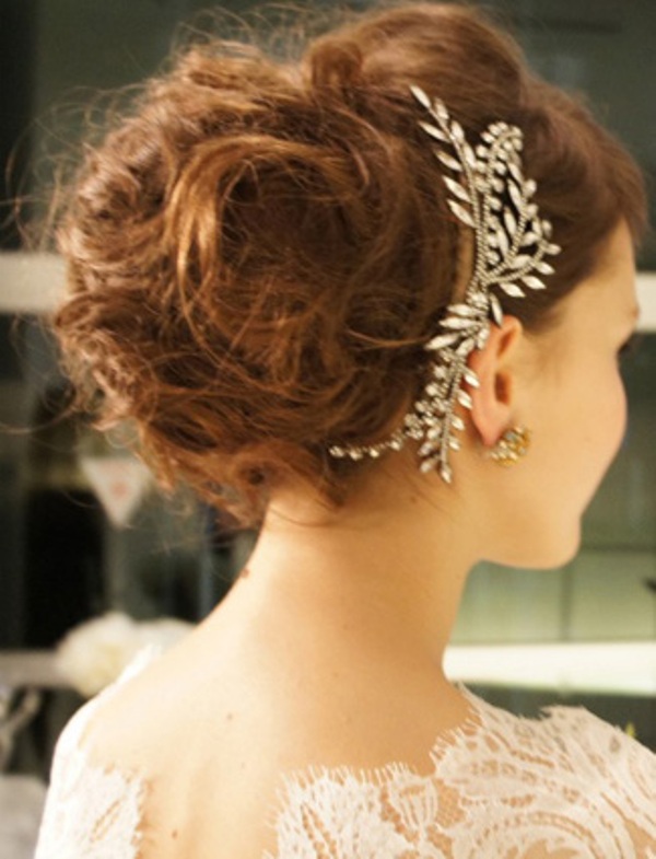 A super messy and wavy wedding updo with teased hair and an embellished headpiece is a refined idea for a modern and romantic bride