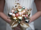 a beautiful pastel and silver Christmas ornament wedding bouquet with a satin ribbon is a pretty and out of the box option
