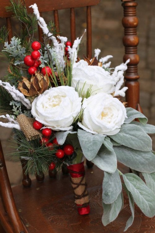 a Christmas wedding bouquet of white blooms, berries, pale leaves, greenery and dried flowers is a pretty idea for a Christmas bride