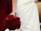 a traditional Christmas wedding bouquet of red roses and berries is always a good idea to rock