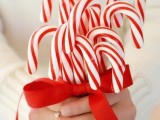 a red and white Christmas wedding bouquet of candy canes is a bold and eye-catchy idea for a bride or briddesmaids