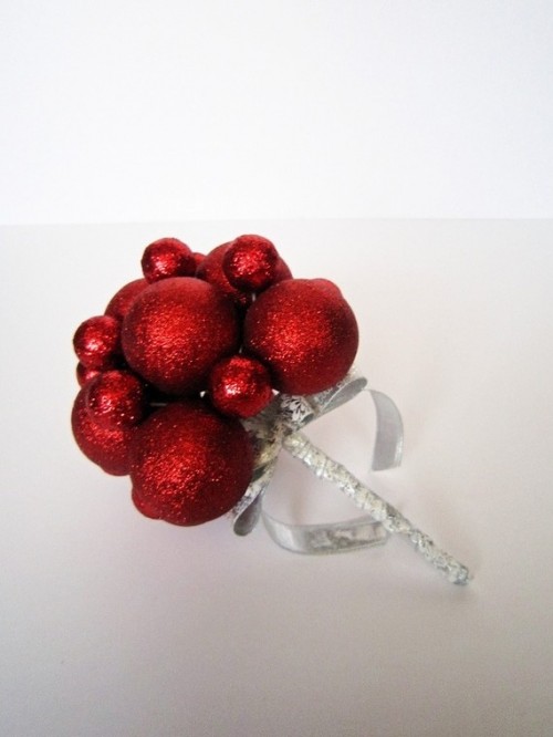a creative red glittter Christmas ornament bouquet with a silver wrap and a base is a unique and bold idea