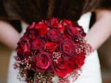 a red and burgundy rose wedding bouquet with red berries is a great idea for a Christmas bride