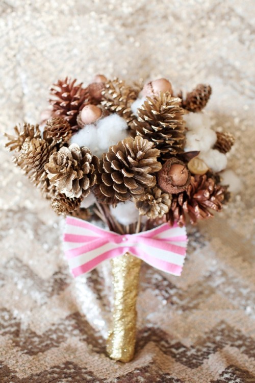 a Christmas wedding bouquet of gilded berries, nuts and cotton with a striped bow for a non-traditional Christmas bride