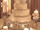 a white and silver Christmas wedding cake decorated with bows and rhinestones and a large embellished bow is a very refined option for such a wedding