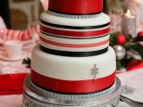 a red, black and white striped Christmas wedding cake decorated with silver snowflakes is a pretty and cozy dessert to rock