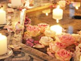 a pool with floating pink and white roses and candles looks magical and very beautiful and charms with romance