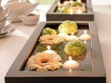 a black box with floating pastel blooms and candles is a gorgeous zen and minimalist wedding centerpiece to try