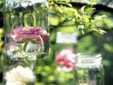 hanging jars with floating neutral and pink blooms are lovely decor for any outdoor wedding, especially for a rustic one