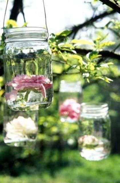 hanging jars with floating neutral and pink blooms are lovely decor for any outdoor wedding, especially for a rustic one