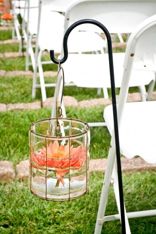 a chic jar with a floating coral bloom is a beautiful decoration for a wedding aisle, it won't require much effort or money