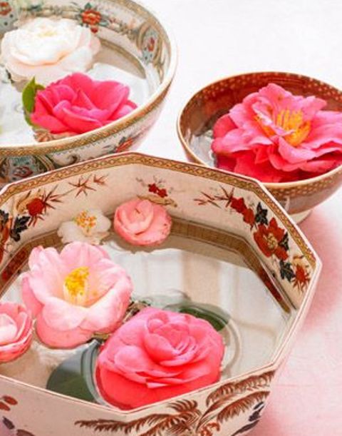floral bowls with floating pink blooms are lovely and bold wedding decor, they can be used as centerpieces or just decorations