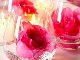 wine glasses with floating bold pink roses are lovely for stylish wedding decor and can be used anywhere