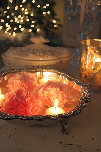 a vintage silver bowl with floating pink blooms and candles is a lovely idea for a romantic wedding