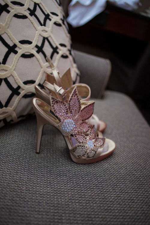 whimsical high heels with large sparklign flower detailing on one side are amazing for a modern glam wedding and for a bride who wants to stand out