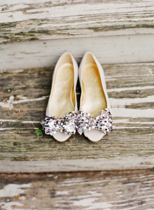 shiny white wedding shoes with sequin bows on top are a playful and cool idea that every bride may rock
