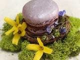 macarons placed into little fake nests and decorated with blooms and moss