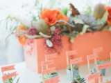 mini succulents in colorful pots with bright markers are nice for a spring or summer wedding