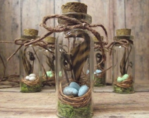 mini spring jars with nests, fake eggs, feathers, moss and rope for a natural spring wedding