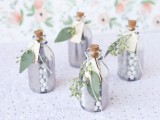 mini silver bottles with candies decorated with fresh greenery and leaves are cool spring wedding favors