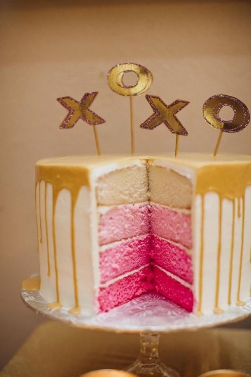 a pink ombre wedding cake with caramel drip and gold letter toppers is amazing with Valentine's Day