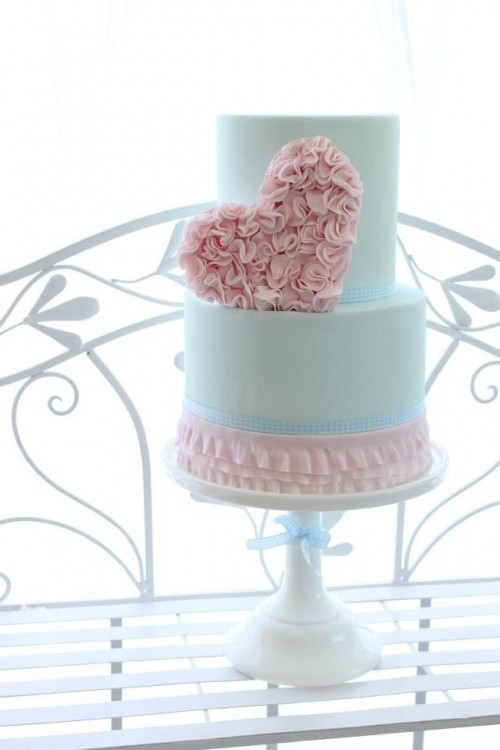 a romantic Valentine wedding cake in pink and mint, with a floral heart, ruffles is a chic and beautiful idea