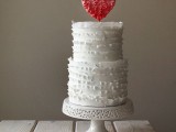 a white ruffle wedding cake with a red ombre ruffle topper is a lovely and fresh idea for a Valentine wedding