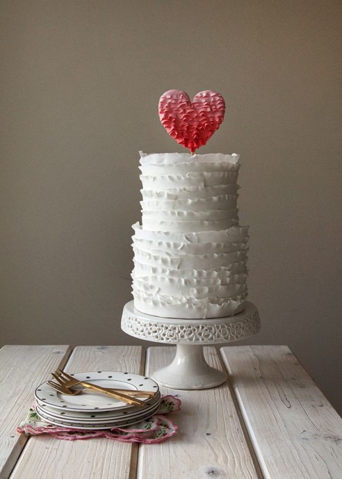 a white ruffle wedding cake with a red ombre ruffle topper is a lovely and fresh idea for a Valentine wedding