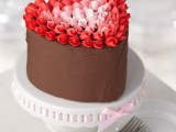 a chocolate heart-shaped wedding cake topped with red and pink cream looks beautiful and gorgeous