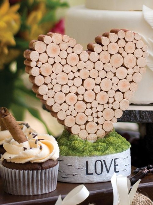 a rustic or vineyard wedding centerpiece of a wood piece, moss and a heart made of corks is a bold idea