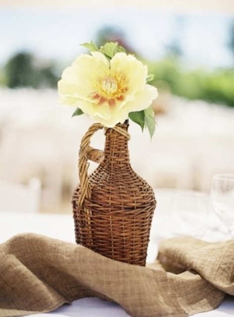 a fiasco with a single neutral bloom is a very refined and chic wedding centerpiece for any vineyard wedding